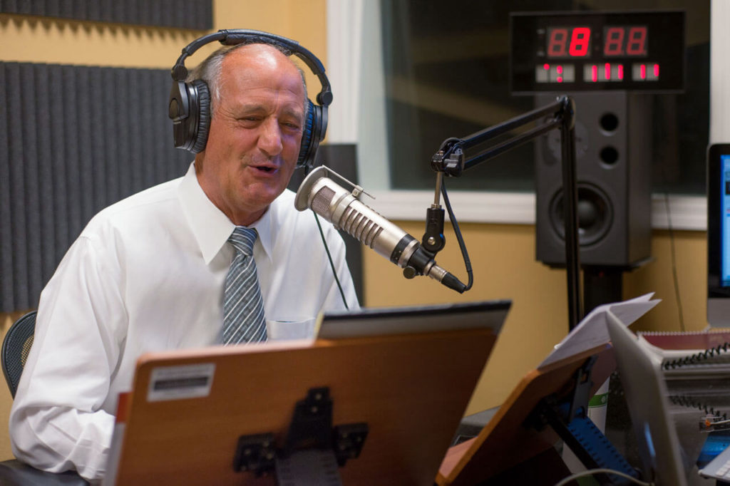 Pastor Trieber speaks to the KNVBC Radio family during a live broadcast